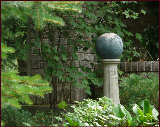 A focal point, in any season, can pull together an otherwise nondescript scene. This gazing ball is surrounded by woody and evergreen plant material surround, so will have the same effect in winter as well. Photo: Sue Gaviller